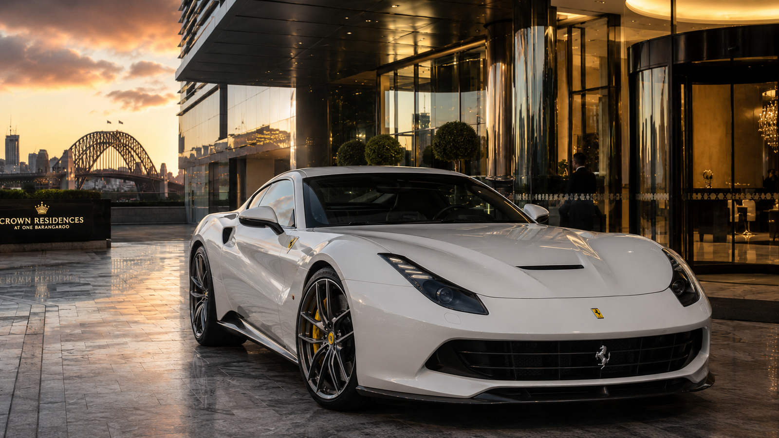 White Ferrari arriving at the Crown Residences entrance at One Barangaroo, Sydney Harbour Bridge visible at sunset